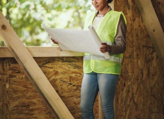 shot-african-female-architect-checking-plans-construction-site-new-wooden-house-she-is-wearing-protective-workwear-white-helmet_360066-21349.jpg